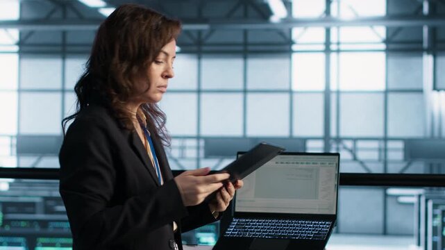 Technicians use tablet in a server room to optimize resource utilization and power management settings, combining power management, resource optimization and UPS configuration.