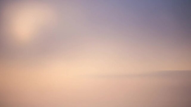 Soft pastel orange and purple abstract gradient background.