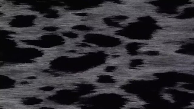 A turbulent dark ocean surface at night reflects shimmering moonlight as rhythmic waves roll through infinite shifting liquid patterns while deep shadows dance across the chaotic moving tidal