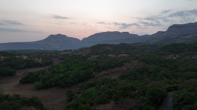 Forested Sahyadri valley and road at dawn near Bhandardara India