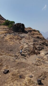 Vertical hiker video descending Ratangad near fort ruins Maharashtra India