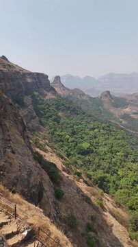 Vertical aerial video of Ratangad fort rampart wall on the ridge Maharashtra