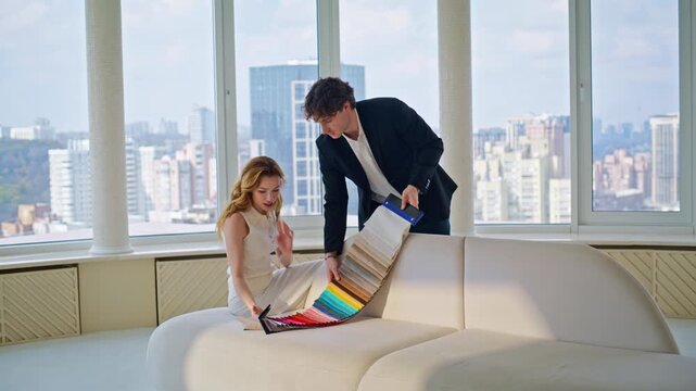 Woman choosing sofa upholstery fabric samples designer. Apartment renovation