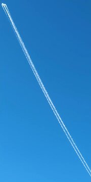 Airplane contrails crisscrossing a clear blue sky on a sunny day, airplane contrails, blue