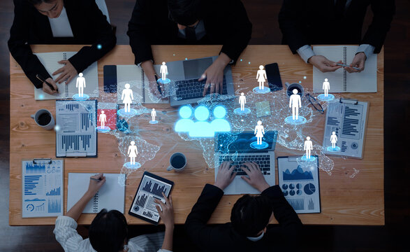 Business Team Collaborating on Data Analysis with Digital World Map and Networking Icons Overlaid on Conference Table. Entropy.
