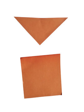 Orange paper triangle and square shapes cut out from craft paper isolated on transparent background