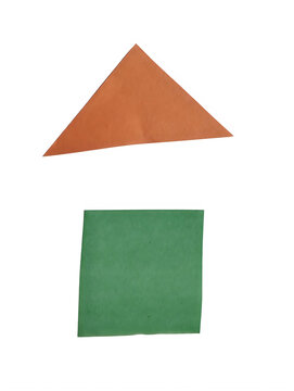 Orange paper triangle shape placed on top of a green paper square shape isolated on transparent background