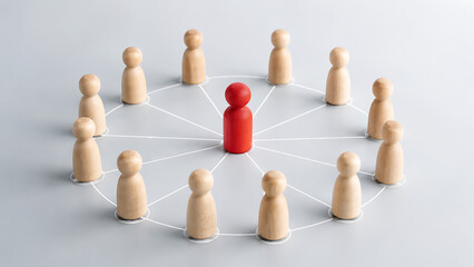 Obraz premium Diverse Wooden Figures Connected in a Network with a Red Leader Standing Out in the Center