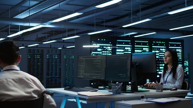 Wheelchair user monitors cybersecurity risks inside a data center setting, using network security, data protection and accessible workplace as part of enterprise server administration