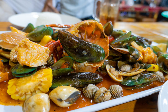 Delicious mixed seafood platter with crab and clams in spicy sauce