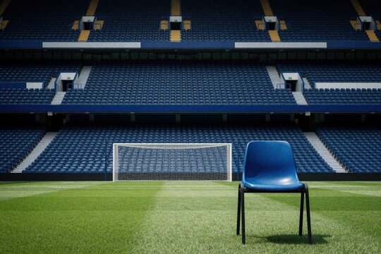 Single plastic blue chair stands on green grass turf inside empty football arena. Soccer goal net sits behind seat with rows of tiered stadium benches in background. Modern sports field layout waits