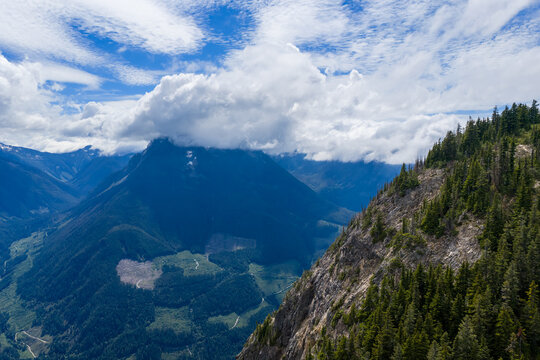Dramatic Cloud-Covered Mountain Ridge Overlooking Forested Valley Near Hope, British Columbia, Canada