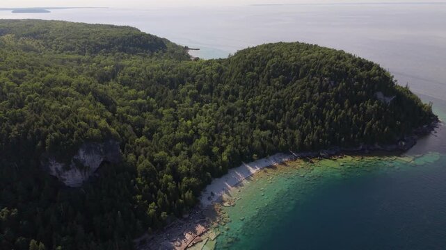 Bruce Penisula National Park, Canada - May 8 2026: Rugged limestone cliffs and crystal-clear turquoise waters frame the scenic Georgian Bay shoreline near the famous Grotto in Bruce Peninsula National