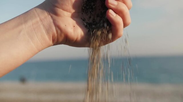 Close Up of Woman Holding Stones on Beach in Warm Summer Light