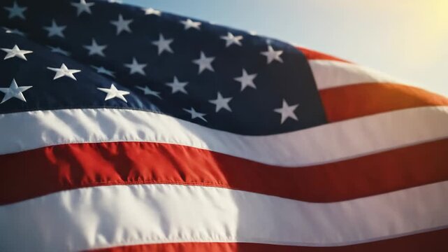 American flag waving in the wind under sunlight