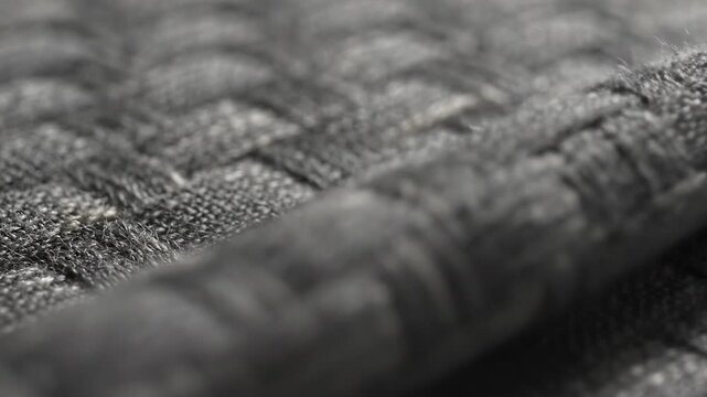 Close up of grey woven fabric rippling
