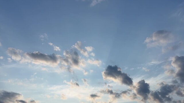 Sun rays through clouds in evening sky
