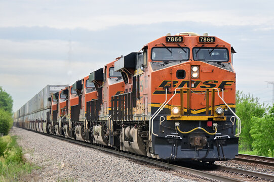 A total of six Burlington Northern Santa Fe locomotive umits, arranged elephant style, ptovide an impressive amount of horsepower in leading an intermodal freight train eastbound through Illinois.