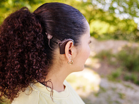 Cochlear implant in deaf woman head. Hearing Aid