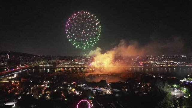 Montreal, Canada - July 12 2026: A stunning 4K aerial drone view capturing vibrant, colorful fireworks exploding over the Montreal skyline and river during the international fireworks competition