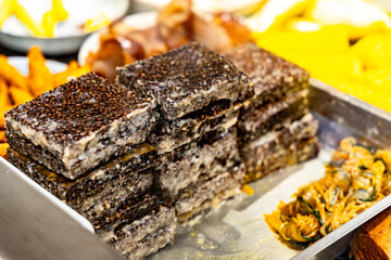 Fototapeta premium one of Taiwan's most iconic and unique street food delicacies—Pig Blood Cake (Pig's Blood Pudding / Pork Blood Cake)