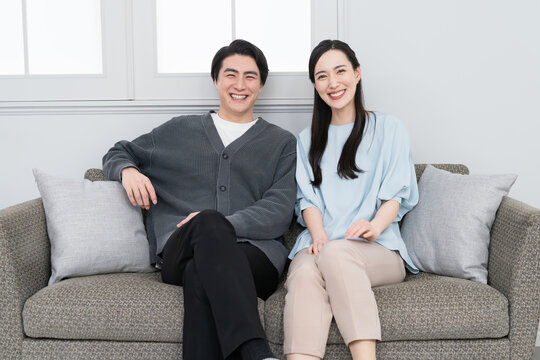 ソファーでくつろぐ若い男女　ライフスタイルイメージ