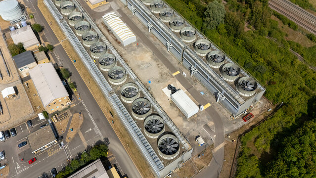St. Neots, United Kingdom - 23 July 2026: Aerial view of Little Barford Power Station showing the large cooling fan array, industrial buildings, and surrounding greenery.