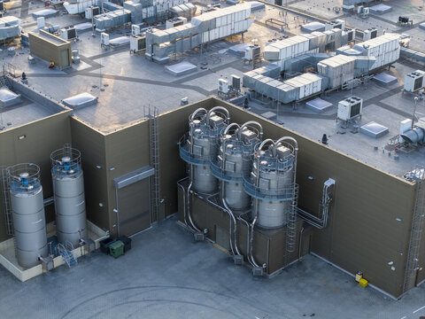 Dobczyce, Poland - 22 July 2026: Aerial view of the Wawel SA production facility with large industrial stainless steel silos, rooftop ventilation units, and factory building.
