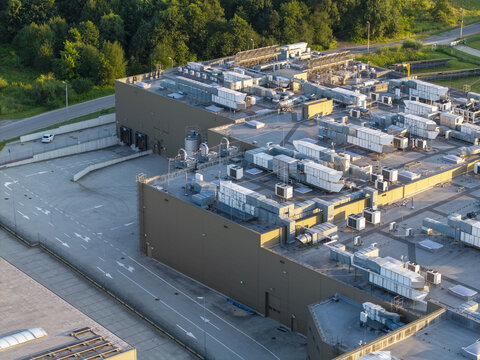 Dobczyce, Malopolskie, Poland - 22 July 2026: Aerial view of Wawel SA production facility with industrial rooftops, ventilation units, and paved areas in late afternoon light.