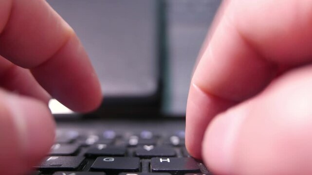 POV (zoom out): hands typing on a computer keyboard. A black keyboard. A wireless keyboard. A dusty keyboard. A dirty computer keyboard. Writing, close-up.