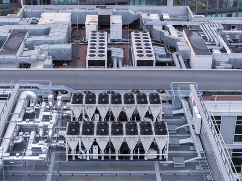 Krakow, Poland - 24 July 2026: Aerial view of data center ai cooling system with industrial ventilation units and metal pipes on a rooftop.