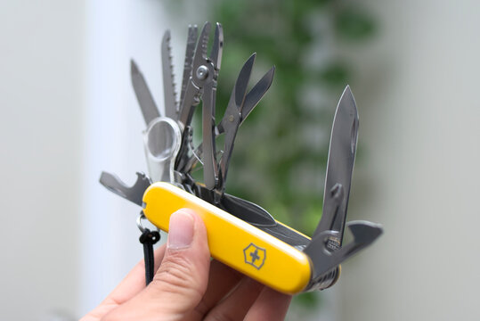 ZAPOPAN, MEXICO - JULY 28, 2026: Hand holding open Victorinox Swiss Army knife with tools deployed.