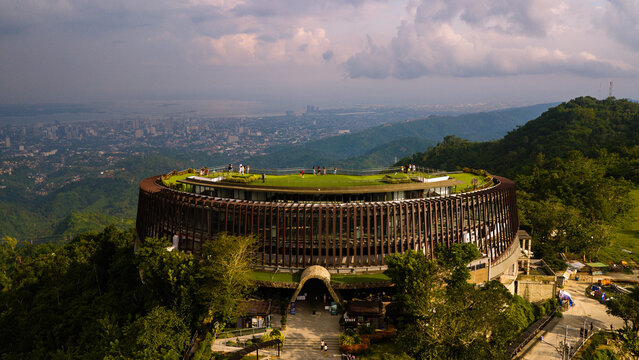 Cebu City, Philippines - 17 July 2026: Aerial view of the Temple of Leah in Busay, featuring circular architecture, green rooftop, and panoramic views of the city skyline.