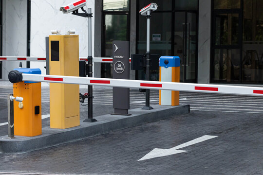 Secure parking entrance with automated barrier system and surveillance cameras