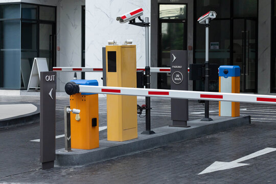 Secure parking entrance with automated barrier system and surveillance cameras