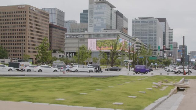 Slow-motion Wide of Tourists Facing the National Museum of Korean Contemporary History Across the Street from Gwanghwamun Gate