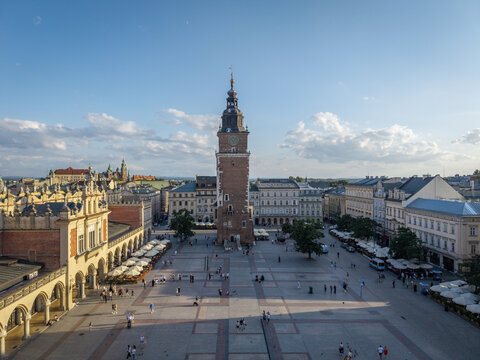 Krakow, Poland - 20 July 2026: Aerial view of the historic Town Hall Tower in the Main Market Square surrounded by traditional architecture and people walking in the old town.