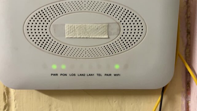 WiFi Router With Fiber Optic Internet Connection Mounted on Wall with working green light indication