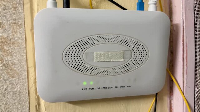 Wireless WiFi Router Installed On Wall With Fiber Optic Internet Network Connection