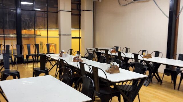 modern cafe interior with empty tables and chairs in casual dining restaurant during daytime