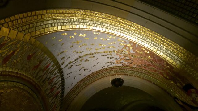 Intricate gold tilework and ceiling paintings inside San Lorenzo church in Gijon