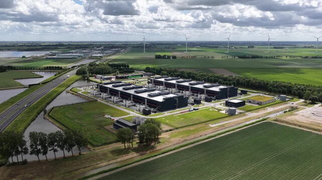 Aerial view of a large scale data center tower building, showing cloud computing infrastructure, digital storage, secure server facilities and modern IT operations.