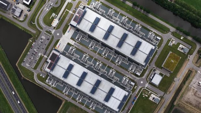 Aerial view of a large scale data center tower building, showing cloud computing infrastructure, digital storage, secure server facilities and modern IT operations.