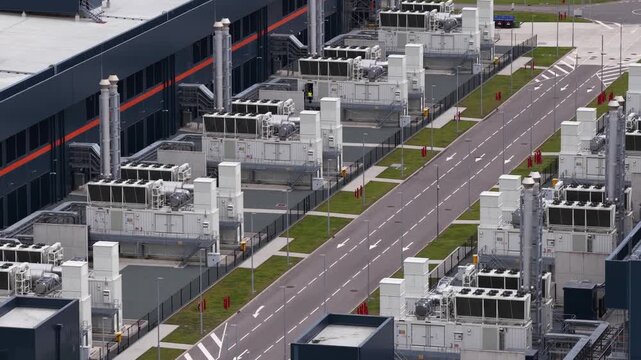 Aerial view of a large scale data center tower building, showing cloud computing infrastructure, digital storage, secure server facilities and modern IT operations.