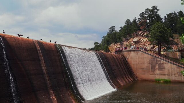 Evergreen Lake dam structure birds resting nature landscape downtown Evergreen Colorado morning sunny clouds blue sky spring summertime small Rocky Mountain town walking hike stair set trails static