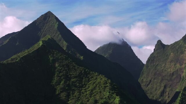 Teahupo'o Tahiti Ito Volcano mountains peaks French Polynesia aerial drone South Pacific Island Mount Ronui Aorai Orohena Vaiau River Valley Tara Huhurahi Ridge afternoon sunny blue sky clouds circle