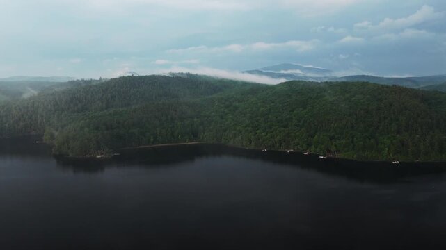 Rainy mist low clouds sunset Lake Schroon aerial drone Steep Bay Town of Schroon Lake Up State New York Pharaoh Mtn Adirondack Mountains June July summer harbor view landscape circle left motion