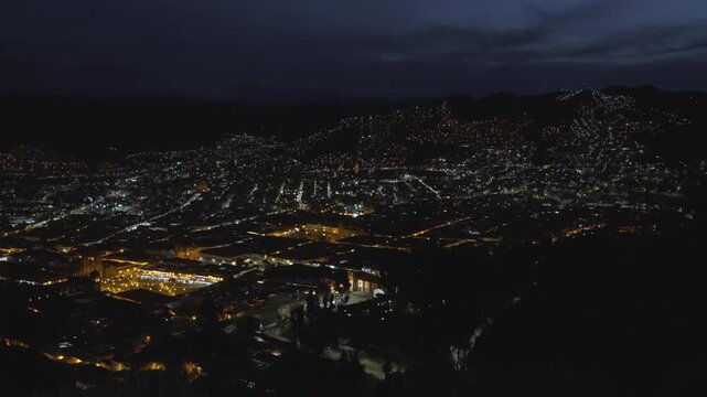 Cusco nighttime evening street lights dusk Plaza de Armas main square city of Cuzco Peru cityscape landscape rainy season Peruvian Andes neighborhood buildings on mountainside Anta Province static