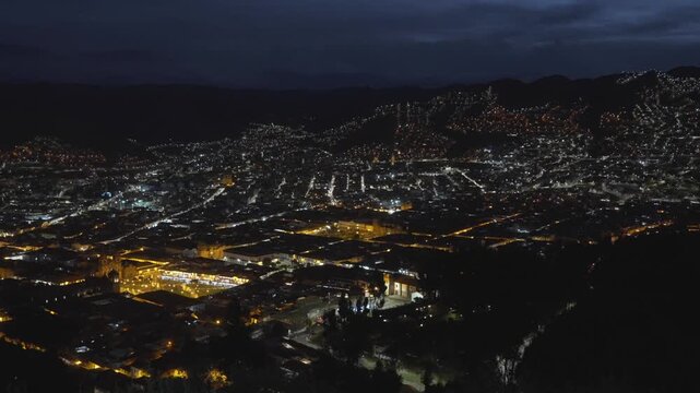 Cusco night evening city street lights dusk Plaza de Armas main square city of Cuzco Peru cityscape landscape rainy season Peruvian neighborhood buildings on mountainside Anta Province Andes static