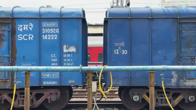 Side view of a blue freight railway wagon moving through Jabalpur Railway Station in Madhya Pradesh India Editorial use only